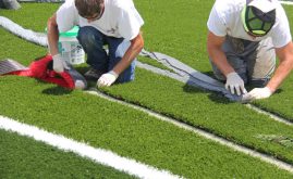 Crew Replacing Turf Systems