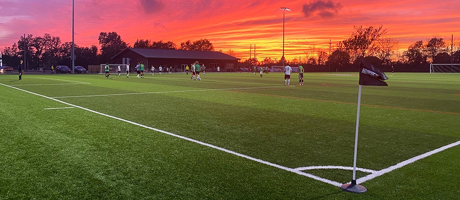 soccer players on artificial grass field turf